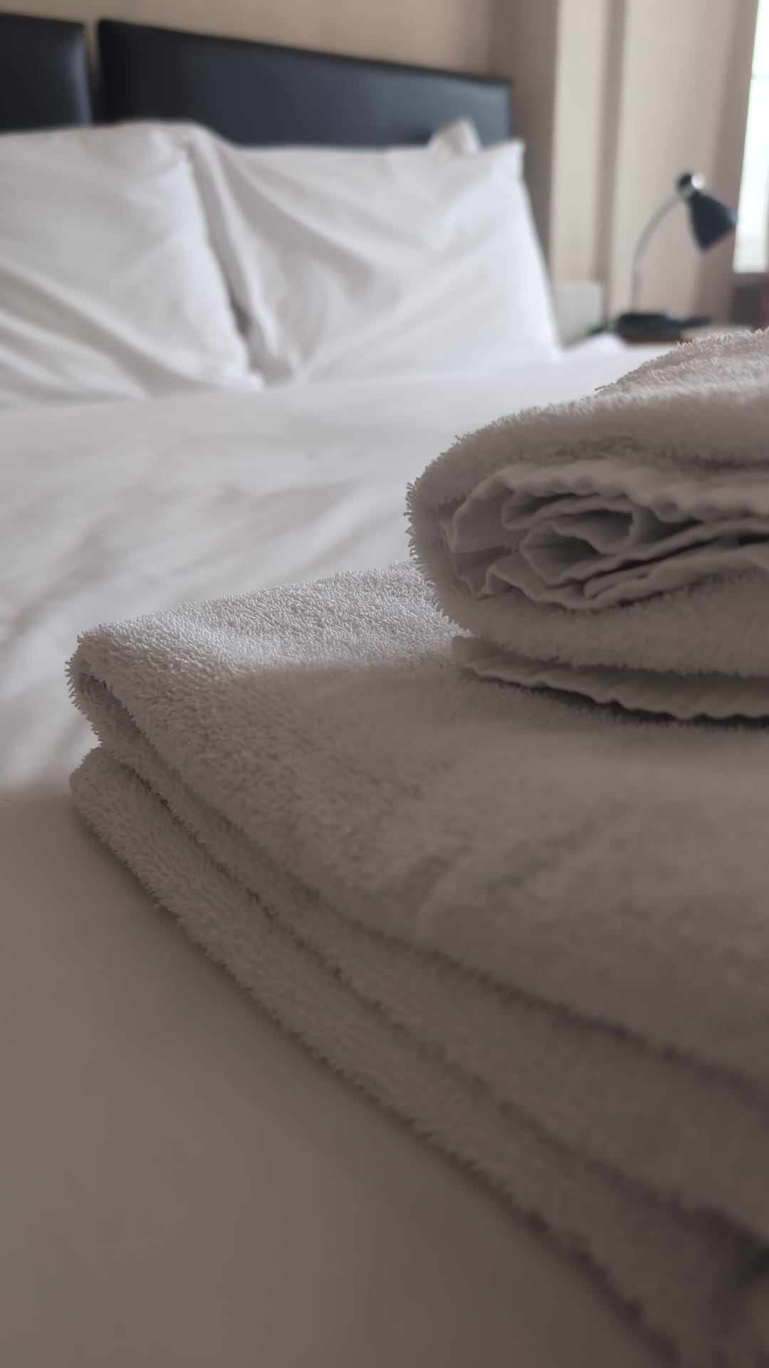Folded towels on bed - The Royal Hotel, Skegness