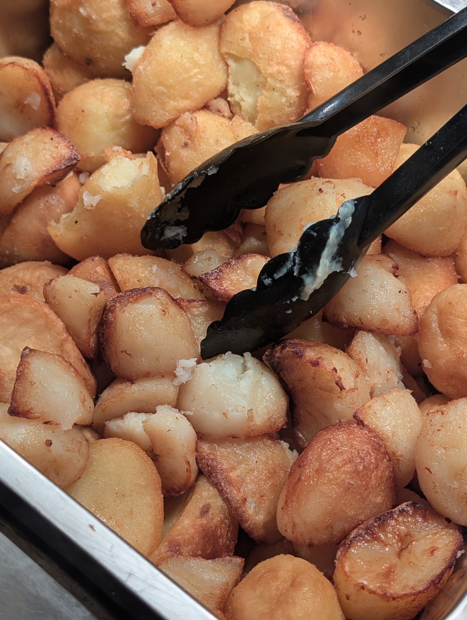Roast potatoes at the carvery station