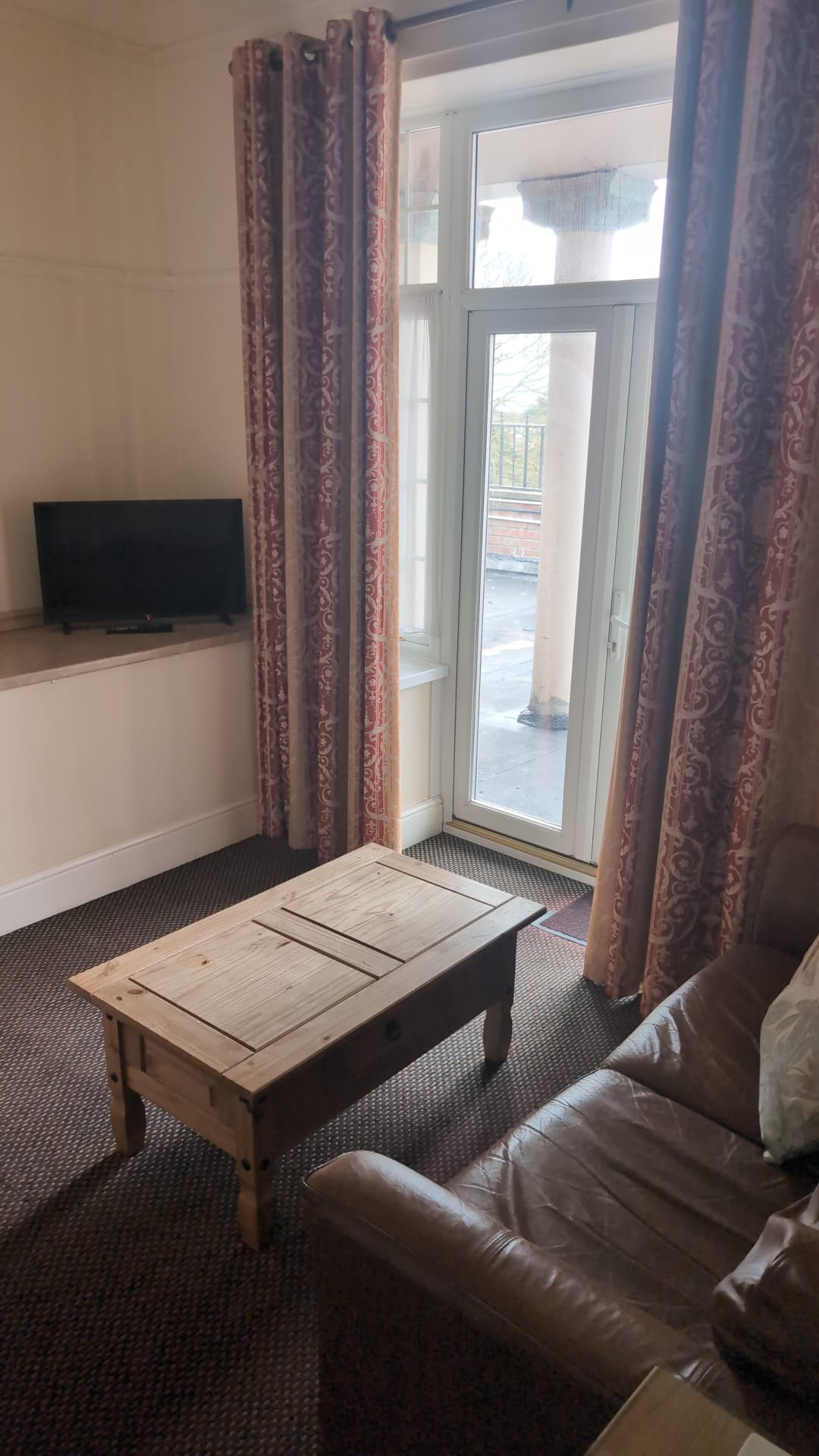 Sitting area with sofa and TV in a guest suite