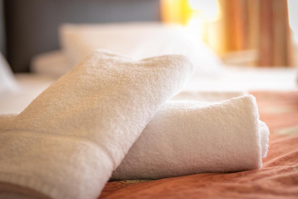 Folded towels on a guest bed