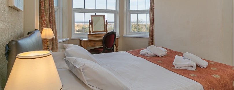 Executive Double bedroom with twin sash windows over the seaview